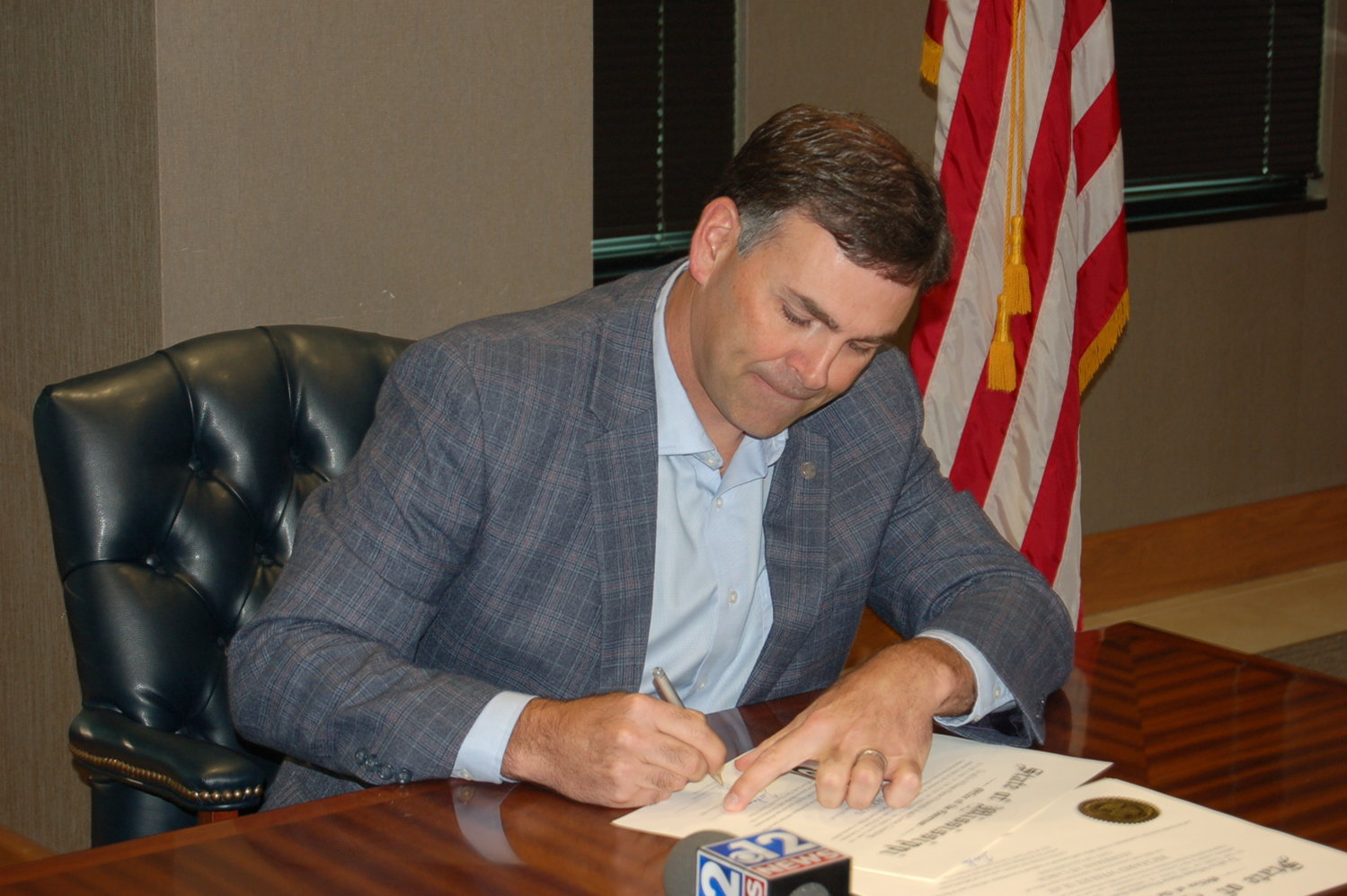 Secretary of State Michael Watson signs commissions for newly appointed Gluckstadt officials. 
